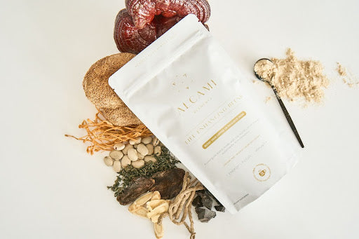 Alcami Elements Life Enhancing Blend packet surrounded by antioxidant-rich ingredients like mushrooms and herbs.
