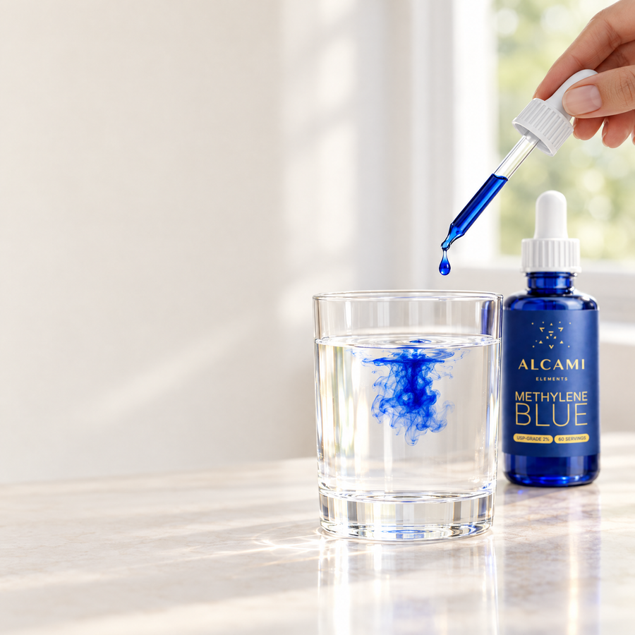 A drop of methylene blue falling from the dropper into a glass of water